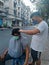 Bangkok, Thailand - January 22th 2022: Street Barber Haircuting a man using Hair Clipper