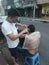 Bangkok, Thailand - January 22th 2022: Street Barber Haircuting a man using Hair Clipper