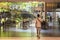 Bangkok, Thailand: man walks in Groove restaurant towards the interior decorated with living trees at Central World shopping mall