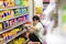 BANGKOK, THAILAND - MARCH 02: Unnamed employee sorts inventory on the shelves of 7-Eleven convenient store on Petchkasem 69 in