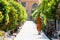 Bangkok, Thailand - March 2019: buddhist monk walking along the alley towards Golden Buddha Temple