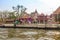 BANGKOK, THAILAND, MARCH, 23, 2018: Outdoor view of stoned buildings of temple at riverside on the Chao Phraya river