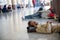 Bangkok, Thailand - March 6th 2020: Homeless individual sleeping on the floor of the Bangkok Railway Station
