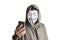 Bangkok, Thailand - May 6, 2018 : A hacker wears a mask wearing a robe. using smartphone theft and attacking data on cyberspace.