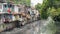 Bangkok, Thailand: slums along a smelly canal Khlong Toei full of mud and plastic garbage. Stock image with logos removed