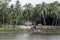 Bangladeshi family walking beside a bathing pond at the ancient Royal Palace of Natore