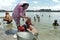 Bangladeshi woman washing clothes in lake