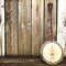 A Banjo leaning on a wooden fence.