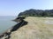 Bank of brahmaputra river with hill and forest.