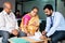 bank employee taking sign from retired senior couple at office for insurence or loan documents - concept of banking