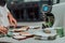 Bank employees using money counting machine while sorting and counting paper banknotes inside bank vault. Large amounts