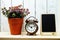 Bank empty wooden easel with artificial plant with alarm clock decoration