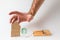 Bank investments and mortgages. Male hand reaching for the cardboard house, lying next to the trap.White background. Copy space