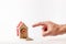 Bank investments and risks. Man`s hand indicates a schematic cardboard house with a mousetrap, with the words MORTGAGE and sign