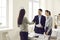 Bank manager, loan broker or real estate agent shaking hands with happy young couple