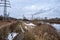 The bank of the river Uvod with a line of power lines going into the distance and Smoking tall pipes