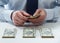 Bank teller counting dollar banknotes