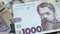 The banknote of 1000 hryvnias falls on the laid out banknotes of 500 hryvnias and rotates slowly. Ukrainian national currency. Rev