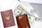 Banknote wallet, pens, passport and airplane on a white background