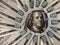 Banknotes of 100 US dollars lie in a circle. The image of Benjamin Franklin is surrounded by hundred-dollar bills. American money