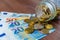 Banknotes and coins on a wooden surface