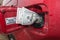 Banknotes, dollars in the fuel filler of a red car