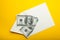 Banknotes in envelope, money in finance concept, isolated in yellow background