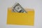 banknotes in a yellow envelope. open envelope with banknotes on a light background. envelope with banknotes. close up of