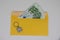 banknotes in a yellow envelope. open envelope with banknotes on a light background. envelope with banknotes. close up of