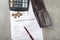 Bankruptcy concept image of a pen, calculator and coins on financial documents