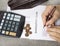 Bankruptcy concept image of a pen, calculator and coins on financial documents