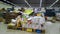 Bankruptcy of supermarket. Clutter, trash and scattered goods on dirty floor in a store. Messy, huge piles paper towels and toilet