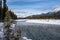 Banks of the Kootenay River in British Columbia Canada in Kootenay National Park during winter. Snow capped mountains in distance