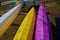 on the banks of the river lie a multi-colored canoe close-up