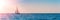 Banner 3:1. Sailboat in the sea in the evening sunlight over sky background. Luxury summer adventure or active vacation concept.