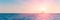 Banner 3:1. Sailboat in the sea in the evening sunlight over sky background. Luxury summer adventure or active vacation concept.