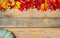 Banner. Autumn wooden background with yellow-red and green leaves, pumpkin and chestnut. Composition on a natural table