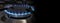 Banner of a close-up of a flame of methane gas stove in a domestic kitchen