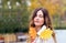 Banner with a close-up sensitive girl in a beige raincoat with yellow leaves