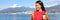 Banner crop for advertising copyspace, landscape of Vancouver in background. Businesswoman drinking coffee using mobile