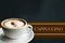 Banner A Cup of Hot Cappuccino on Dark Green Background