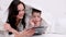 banner family Cosiness mom and son under white duvet playing on a tablet concept heat heating electricity gas apartment