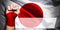 Banner of Flag of Japan painted on male fist, fist flag, country of Japan, strength, power, concept of conflict. On a blurred