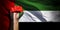 Banner of Flag of United Arab Emirates painted on male fist, fist flag, country of UAE, strength, power, concept of conflict. On a