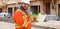 Banner of foreman in orange workwear holding notebook on construction site.