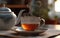 Banner of grey cup with teapot. tea into pot on saucer in soft focus on blurred background