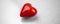 Banner lonely red heart on a simple grey background, concept of love, copy space photo