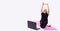 Banner, long format.Handsome elderly woman watching online workout on laptop and using elastic rope band during morning training,