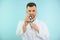 Banner male doctor with a stethoscope on blue background. A young medical worker showing stethoscope close up