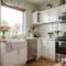 banner ofa kitchen with tulips on the table and white cupboards food on the kitchen counter top